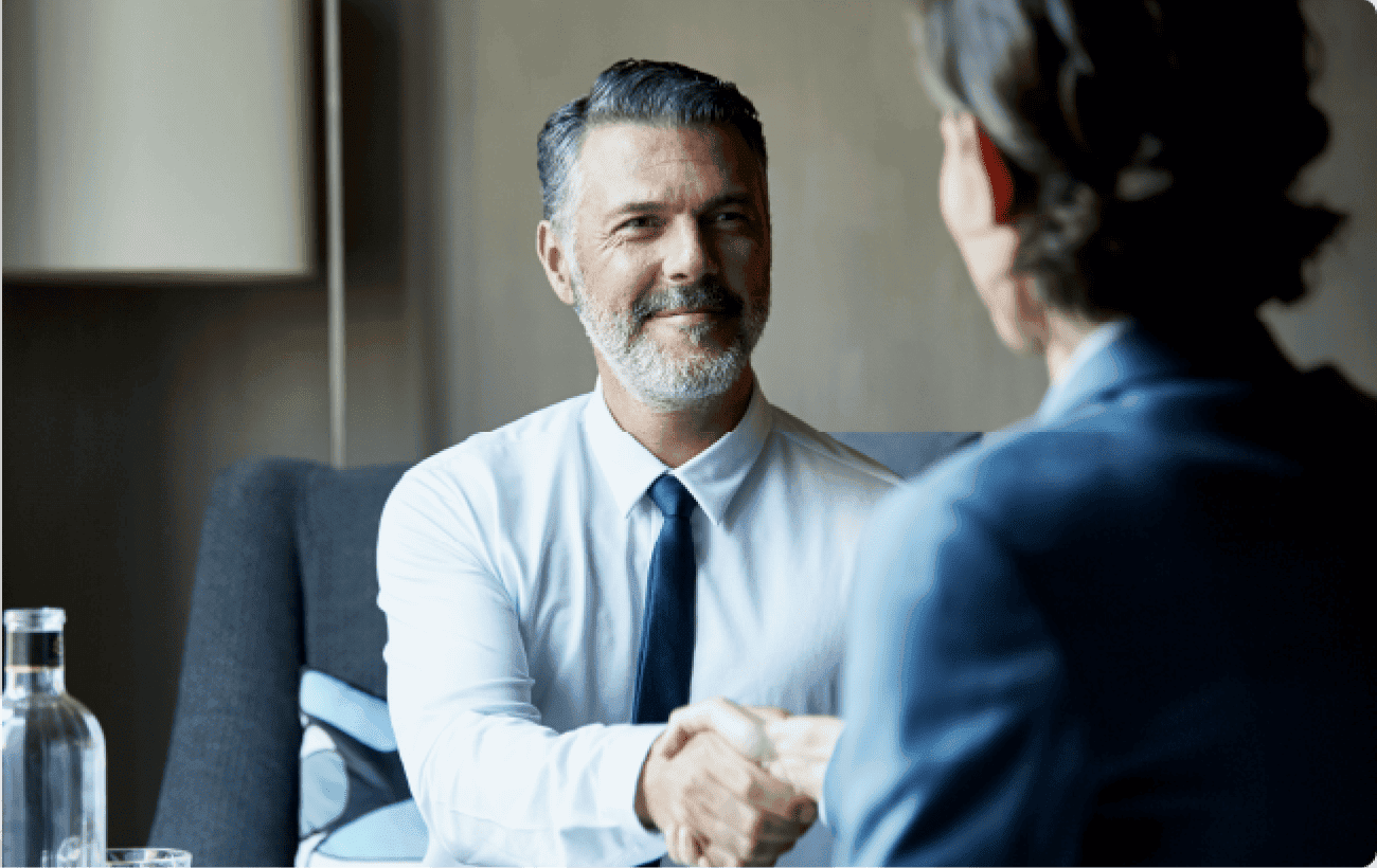 Business professionals shaking hands at a meeting