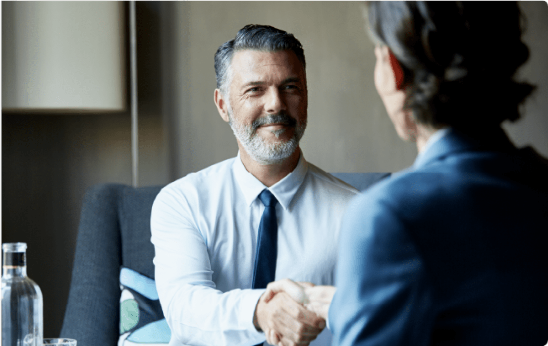 Business professionals shaking hands at a meeting